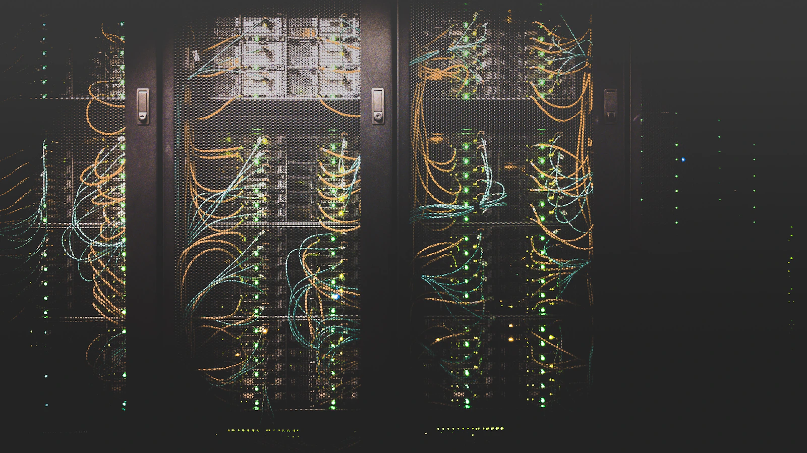 Rows of servers in a data center lit by cool blue light