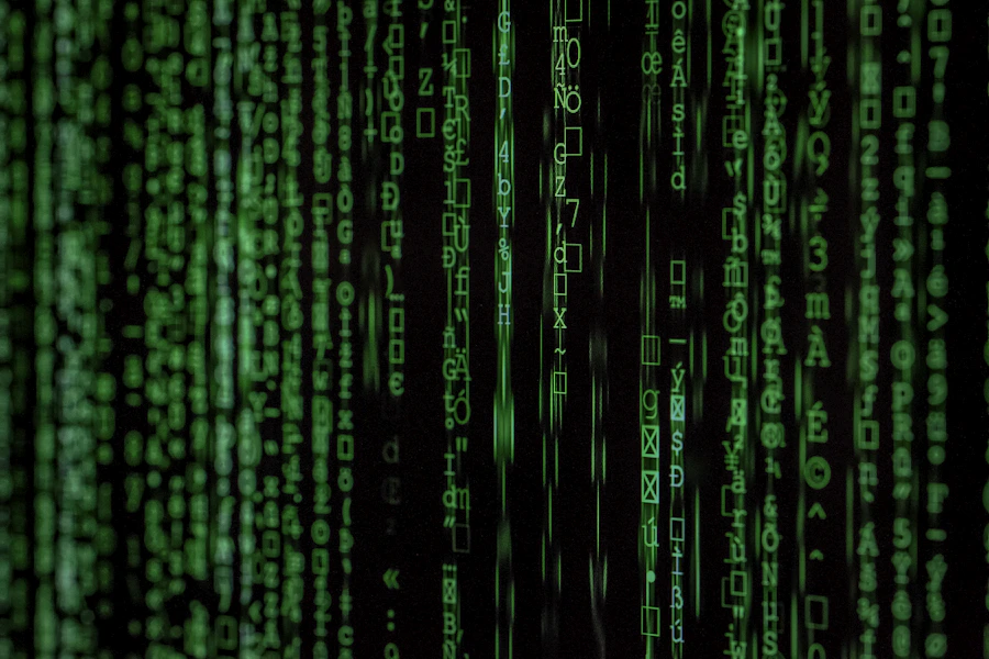 Streams of green code on a dark display representing log analysis